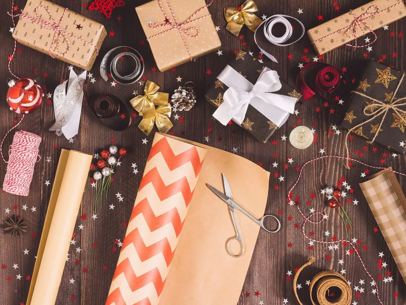 Rolle Kraft-Verpackungspapier mit Schere zum Zuschneiden beim Verpacken einer Weihnachtsgeschenkbox.